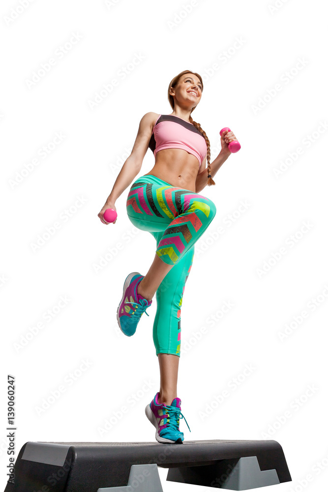 .Sporty girl engaged in step on platform for step in gym .Sporty girl engaged in step on platform for step in gym