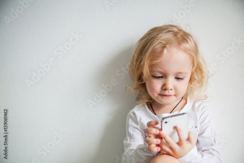 beautiful little girl with a smartphone