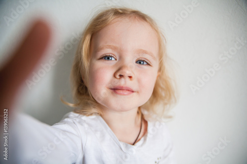 a beautiful little girl making a selfie
