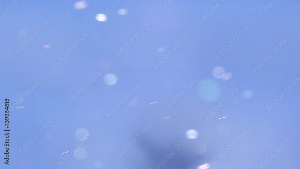 Abstract winter background with snow particles in bokeh Abstract winter background with snow particles in bokeh