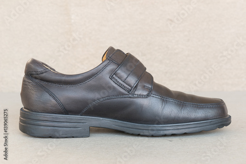 vintage style Black leather shoes on gray background