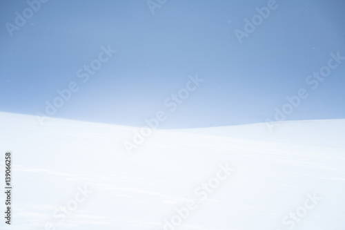 A beautiful, minimalist landscape of flat, snowy Norwegian field. Clean, light, highkey, decorative look.