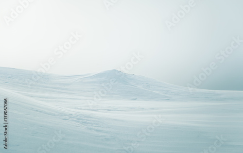 A beautiful, minimalist landscape of snowy Norwegian hills. Clean, light, high key, decorative look.