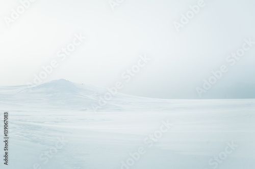 A beautiful  minimalist landscape of snowy Norwegian hills. Clean  light  high key  decorative look.