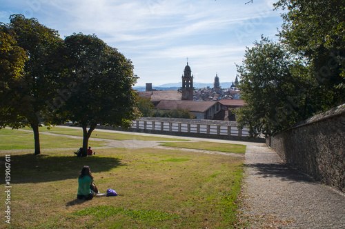 Chica contemplando vistas de Santiago de Compostela desde el Parque del Bonaval photo