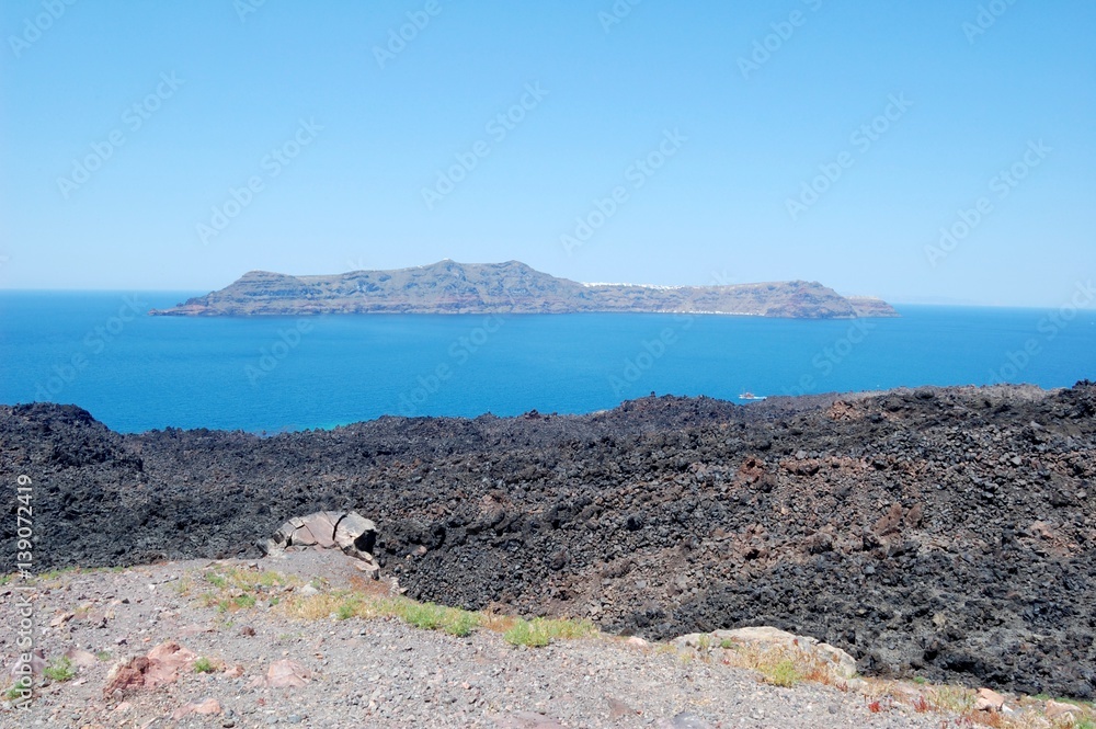 Coast of Santorini volcano, Greece. Caldera. Lifeless emissions of basalt, a reminder of the eruption. The view from the shore/ From a trip to the Cycladic Archipelago