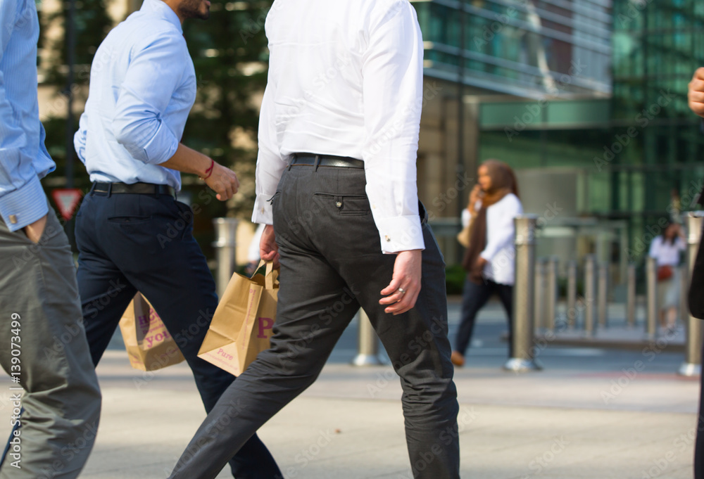 Business people walking on the Canary Wharf square, business and financial aria. Modern life concept
