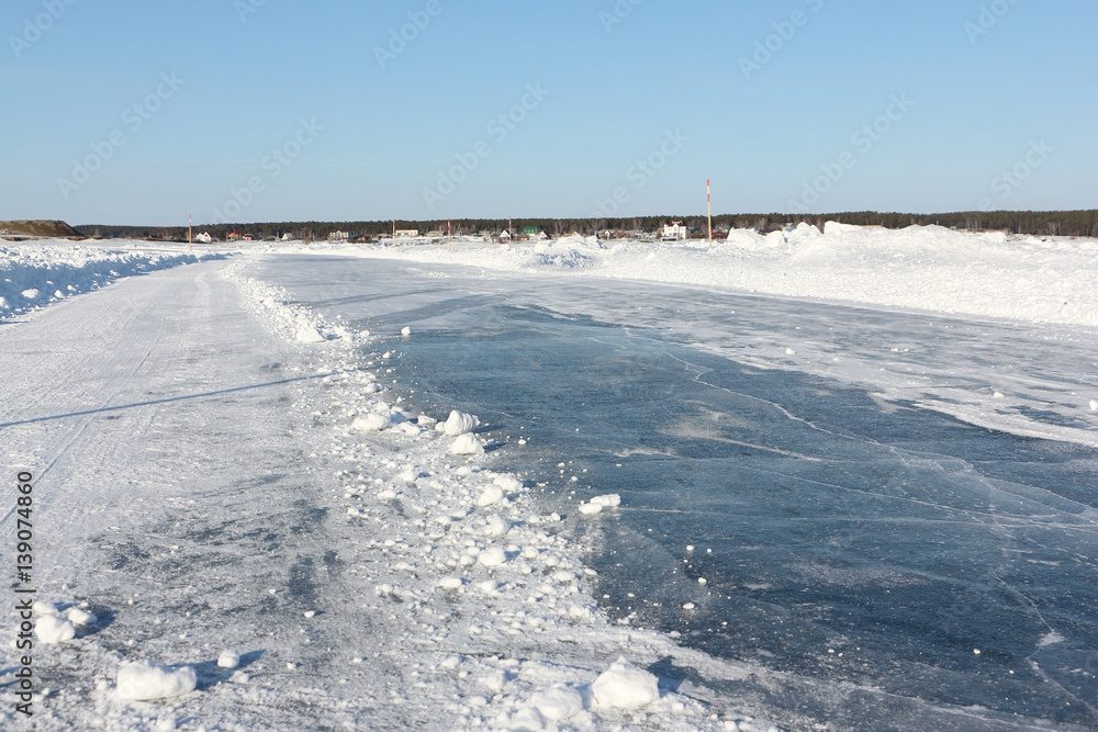 Ice road on a frozen reservoir in the winter, Ob River, Siberia, Russia Ice road on a frozen reservoir in the winter, Ob River, Siberia, Russia