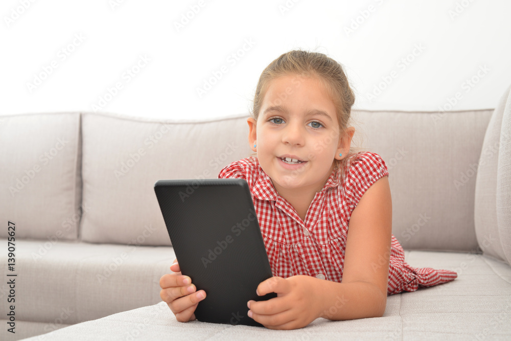 Toddler girl playing games on her tablet Toddler girl playing games on her tablet