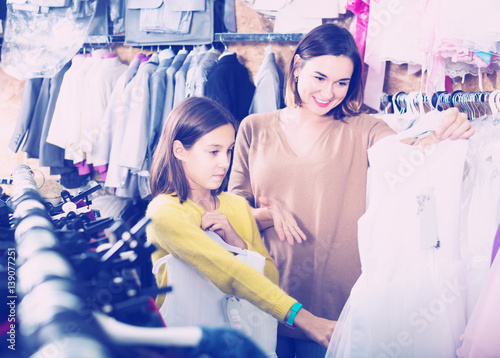 Family choosing dress in shop © JackF