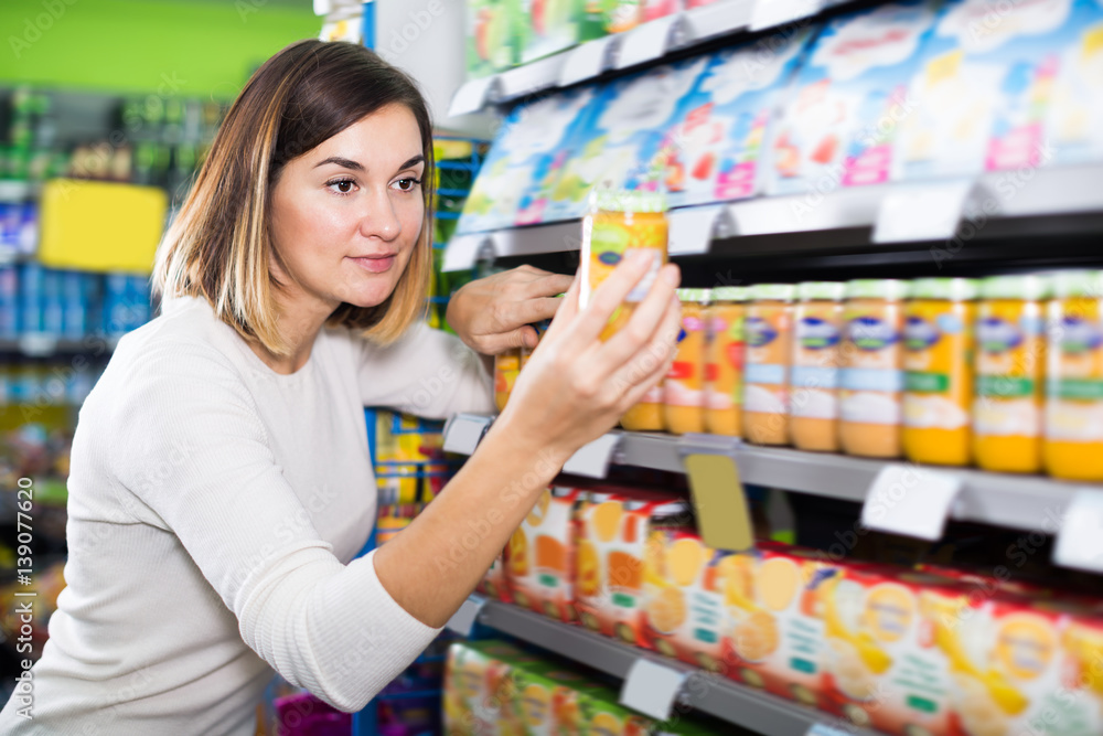 Adult female shopper searching for baby food