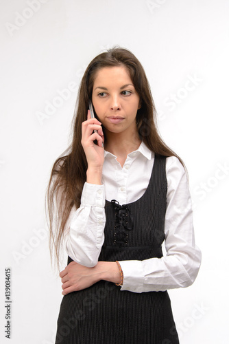 Attractive young business woman using her smartphone, on white