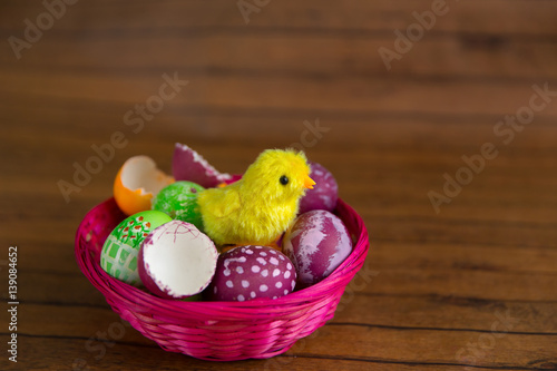 Easter eggs in basket, chick hatching from shell © lenblr