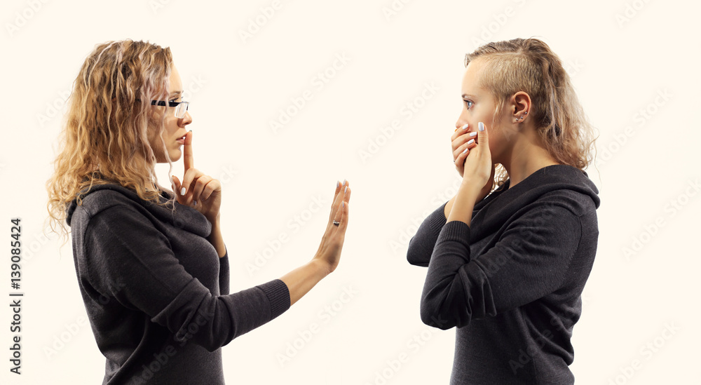Part of series. Self talk concept. Young woman talking to herself, showing gestures. Double portrait from two different side views. Part of series. Self talk concept. Young woman talking to herself, showing gestures. Double portrait from two different side views.
