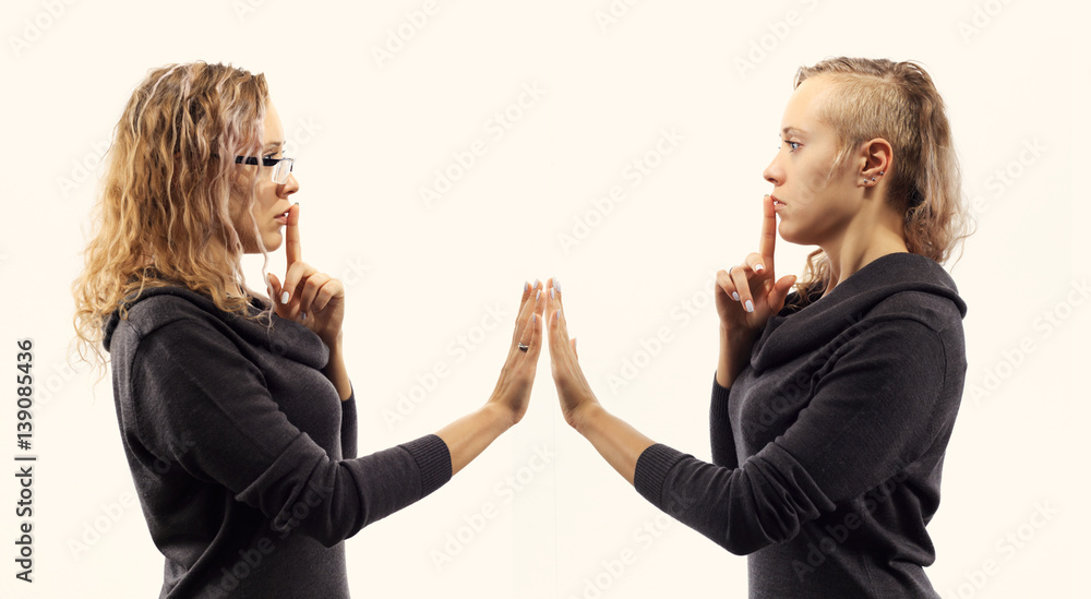 Part of series. Self talk concept. Young woman talking to herself, showing gestures. Double portrait from two different side views. Part of series. Self talk concept. Young woman talking to herself, showing gestures. Double portrait from two different side views.