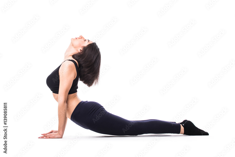 Young woman exercising. Fit sporty brunette doing a plank on yoga mat.