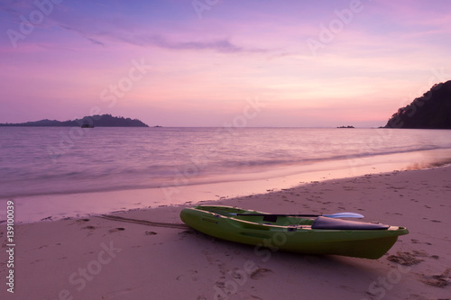 Canoe on the beach at twilight time.