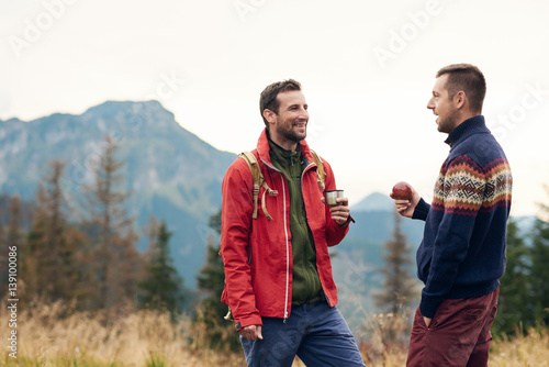 Two men taking a break while trekking in the wilderness