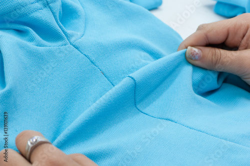Принти на полотні at a garment factory quality control check for defects