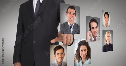 Businessman touching profile pictures of business executives photo