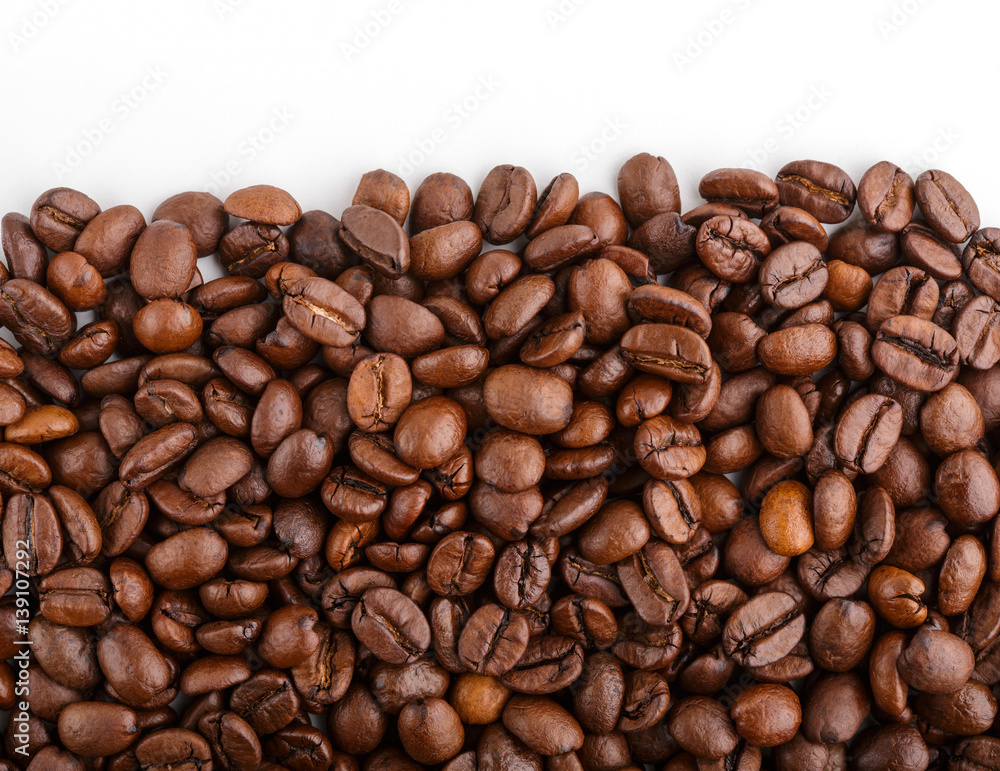 roasted coffee beans isolated in white background. Roasted coffee beans background close up. Coffee beans pile from top on white background with copy space for text. Good morning. roasted coffee beans isolated in white background. Roasted coffee beans background close up. Coffee beans pile from top on white background with copy space for text. Good morning.