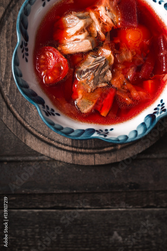 Traditional Russian and Ukrainian beetroot soup borscht on the old background