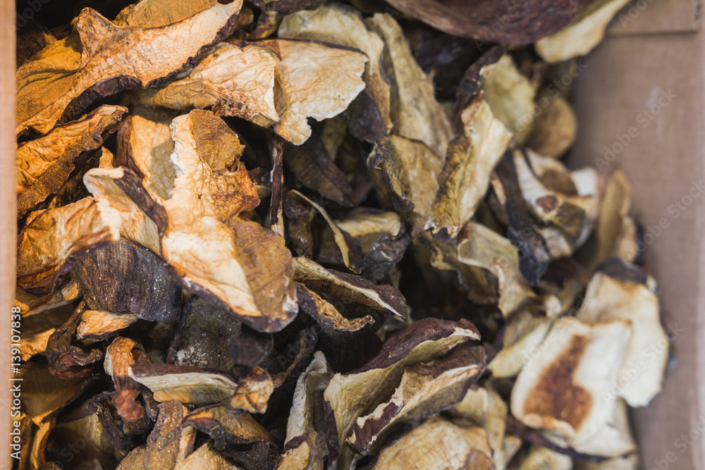 Dried mushrooms boletus in basket, food background