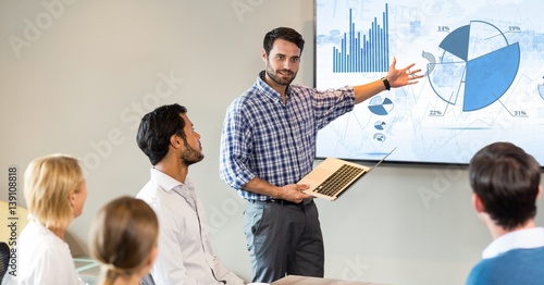 Businessman giving presentation to his colleagues photo