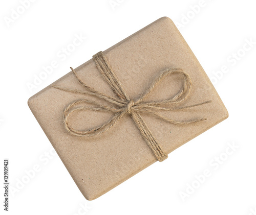 Gift box wrapped in brown recycled paper and tied sack rope top view isolated on white background, clipping path included