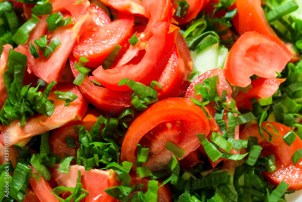 Background of tomato salad with green onions, black pepper and olive oil Background of tomato salad with green onions, black pepper and olive oil