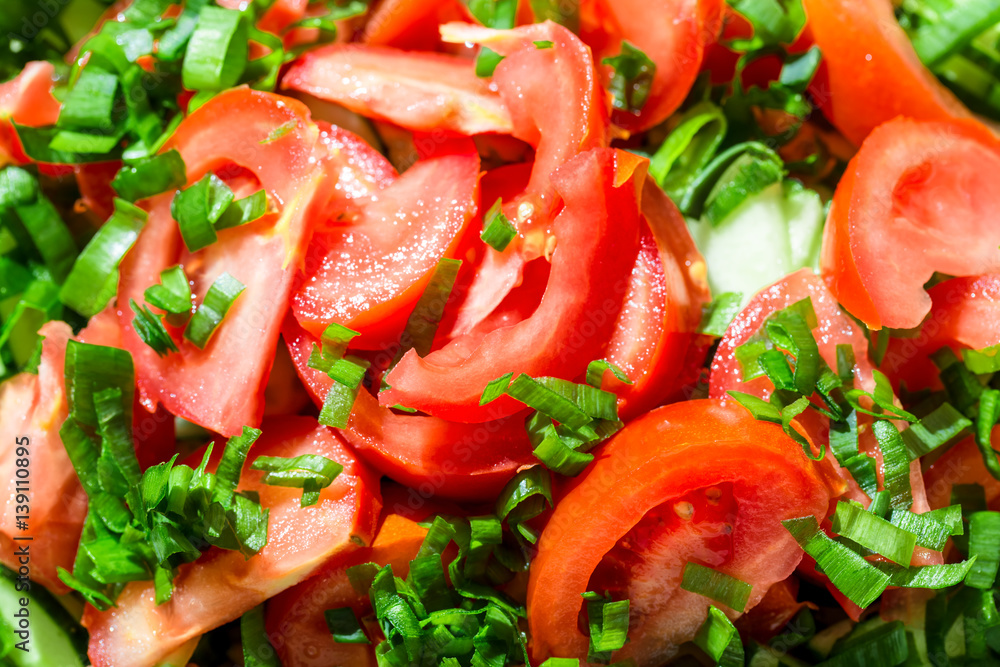 Background of tomato salad with green onions, black pepper and olive oil Background of tomato salad with green onions, black pepper and olive oil