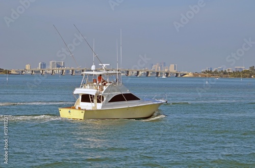 Sport Fishing Boat on the Florida Intra-coastal Waterway with the Julia Tuttle causeway bridge and Miami and North Miami beach skylines in the distant background. © Wimbledon