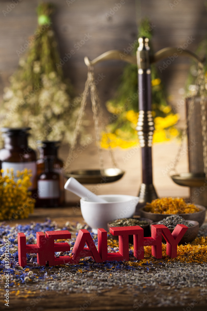 Healthy herbs on wooden table, mortar and herbal medicine