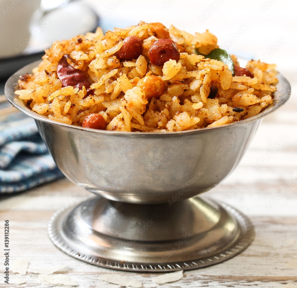 Tamarind Poha / Puli Aval - South Indian breakfast with flattened rice, selective focus Tamarind Poha / Puli Aval - South Indian breakfast with flattened rice, selective focus