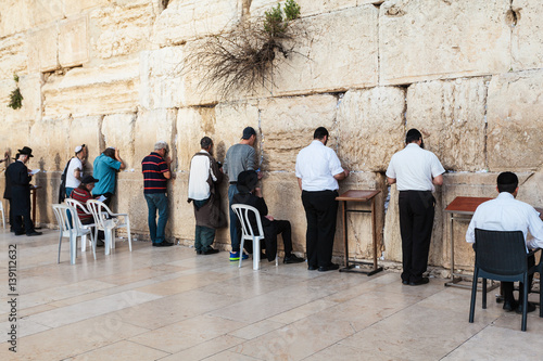 The Western wall or Wailing wall in the old city of Jerusalem, Israel. Jews pray at the wall of the temple. photo