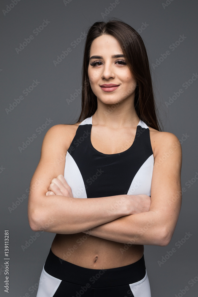 Portrait of a beautiful fitness woman with crossed arms Portrait of a beautiful fitness woman with crossed arms
