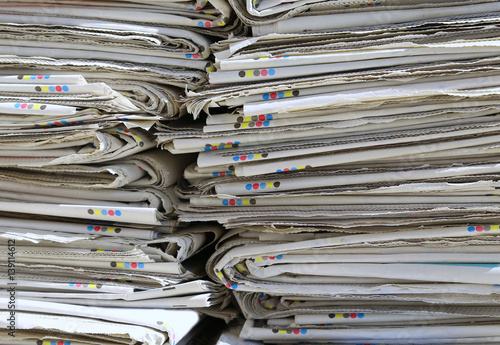 heap of used newspapers on the collection center for recyclable photo