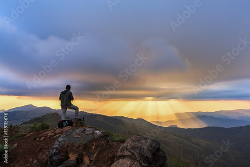 Nature photographer with digital camera on top of the mountain.