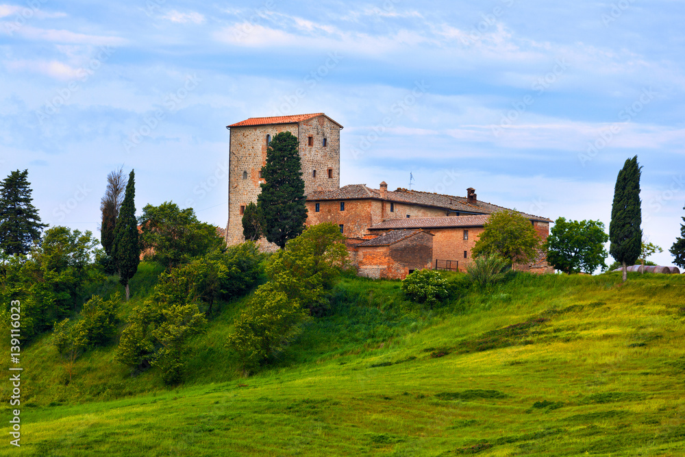 Big stone farmer house on the green hill, Tuscany, Italy