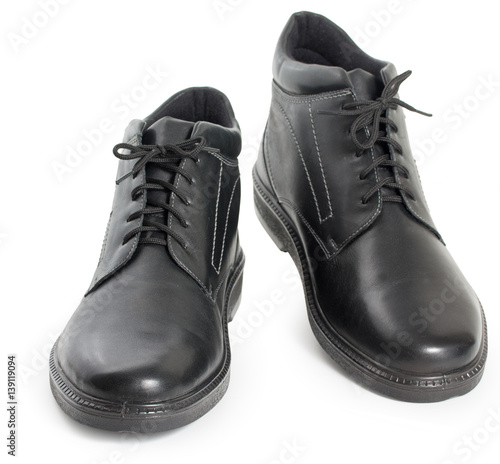 Pair of black mens leather winter boots isolated on a white background