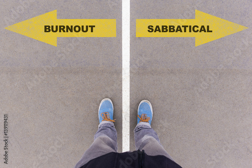 Burnout or sabbatical text on asphalt ground, feet and shoes on floor photo