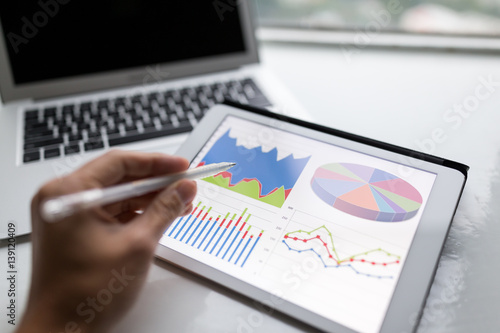 Pen showing the information graph on tablet computer