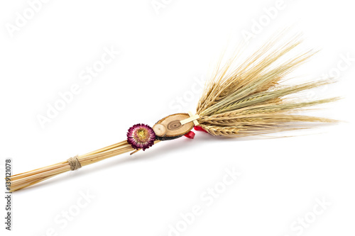 Beautiful wheat bouquet with red ribbon, slice of wood, dry flower and wooden cross, isolated on white. Bozic, Serbian ortodox christmas