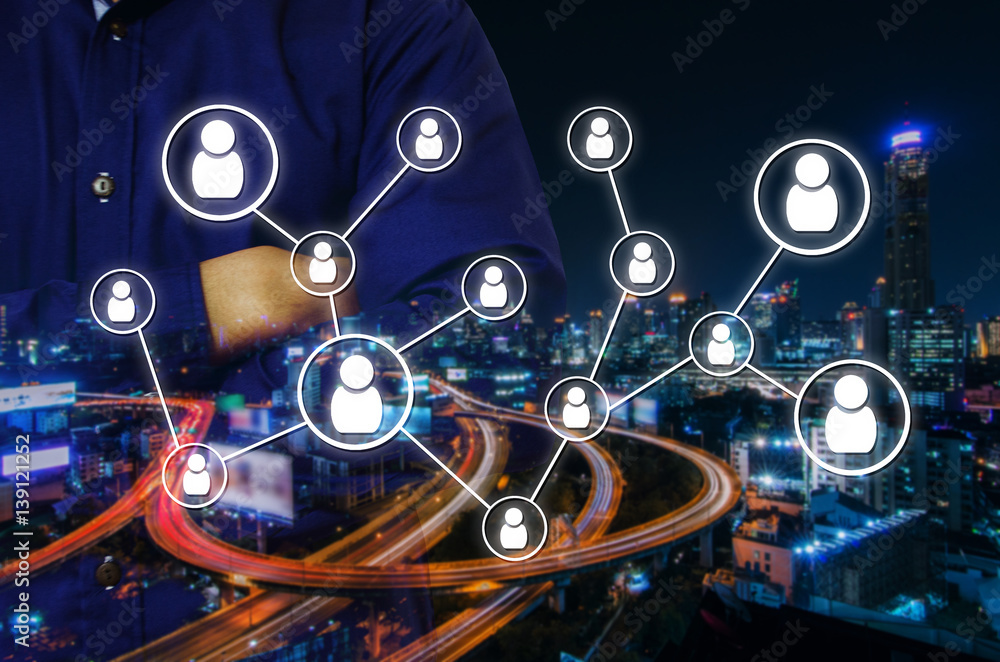 Fototapeta premium double exposure of man crossing arms and social media network connection concept on night city background, color tone effect.