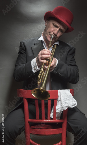 Close up portrait image of a mature jazz man playing a trumpet 