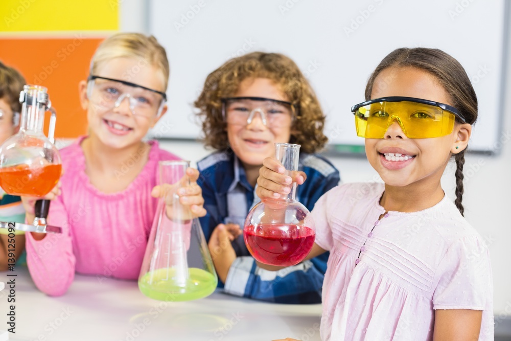 Kids doing a chemical experiment in laboratory Kids doing a chemical experiment in laboratory
