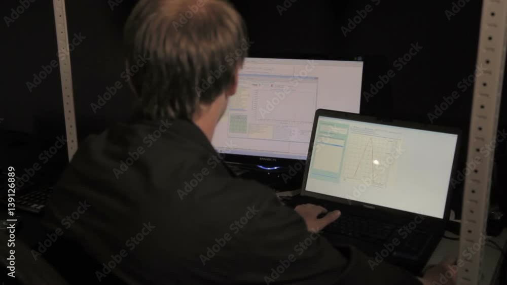 Closeup Middle-age Employee Work in front of two Monitors Closeup Middle-age Employee Work in front of two Monitors