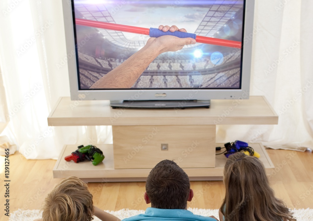 Family watching javelin throw on television at home Family watching javelin throw on television at home