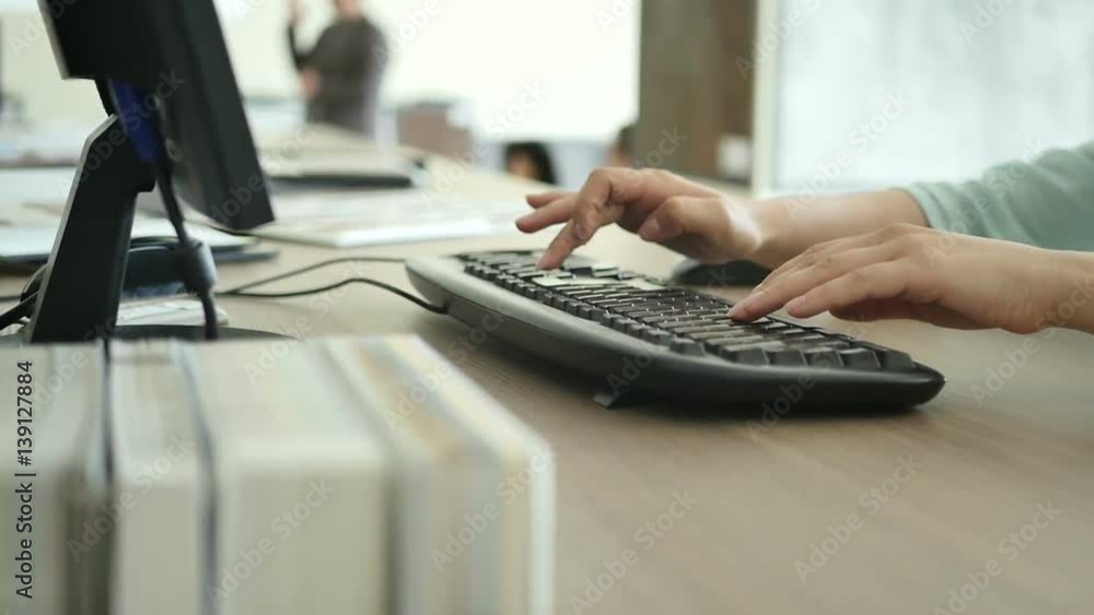 The woman typing on the keyboard in the shop The woman typing on the keyboard in the shop
