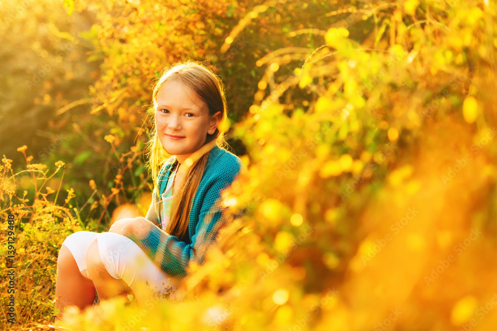 Outdoor portrait of a cute little 8-9 year old girl at sunset Outdoor portrait of a cute little 8-9 year old girl at sunset